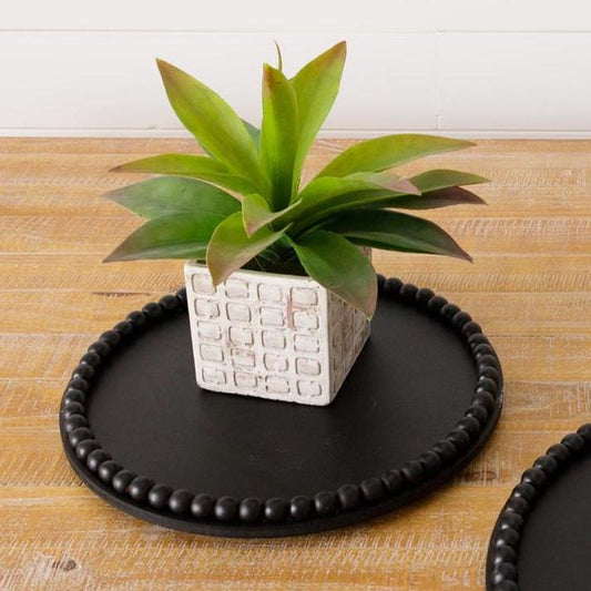 Black round tray with beaded rim